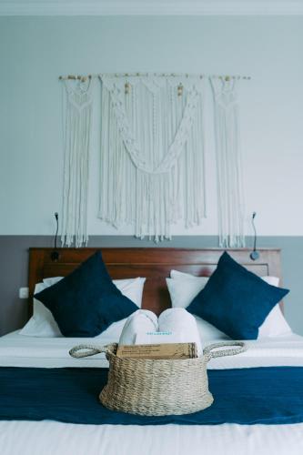 a basket of towels sitting on top of a bed at Escape Bajo in Labuan Bajo
