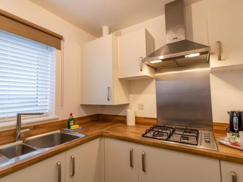 a kitchen with a sink and a stove at Charming Coastal Retreat - 1-Bedroom Flat in Blyth - Pass the Keys in Blythe