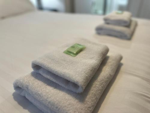 a pile of towels sitting on top of a bed at Pass the Keys Charming Coastal Retreat – 1-Bedroom Flat in Blyth in Blythe