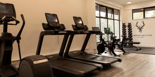 a gym with several exercise bikes and a treadmill at The Bell Inn Hotel in Lyndhurst