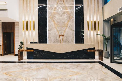 a lobby with a marble floor and a reception desk at The Emporia Hotel in Pamukkale
