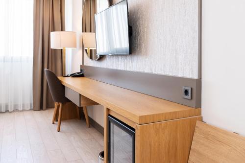a desk in a hotel room with a television at The Emporia Hotel in Pamukkale