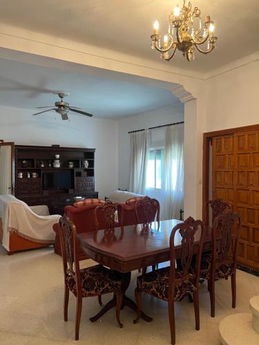 a living room with a table and chairs and a couch at Casa familiar pueblo in Valencina de la Concepción