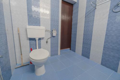 a bathroom with a toilet in a shower stall at UDUPI HOMESTAY Garden Villa in Udupi
