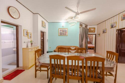a kitchen and dining room with a table and chairs at UDUPI HOMESTAY Garden Villa in Udupi