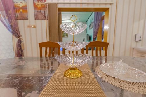 a glass candle holder sitting on a table at UDUPI HOMESTAY Garden Villa in Udupi