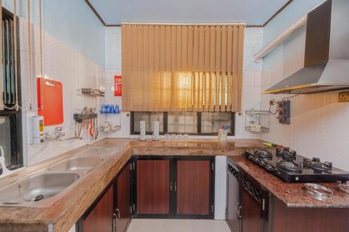 a kitchen with a sink and a counter top at UDUPI HOMESTAY Garden Villa in Udupi