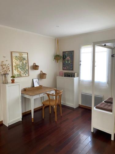 a living room with a table and a table and chairs at La Maison en Bois in Tournefeuille