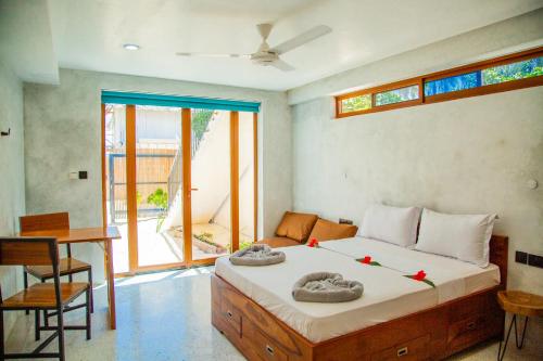 a bedroom with a bed with red flowers on it at Bahari View in Jambiani