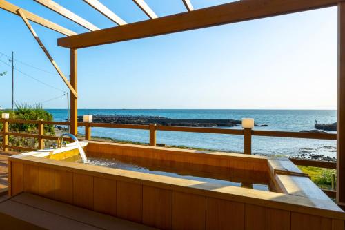 a bath tub with a view of the ocean at StellaStoria HAYAMA Seaside house with open-air bath in Hayama