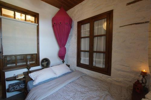 a bedroom with a bed and a window at Home Sweet Home in Agios Georgios Nilias