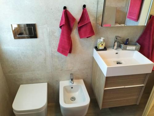 a bathroom with a white sink and a toilet at Gemütliche Ferienwohnung in Agra in Agra