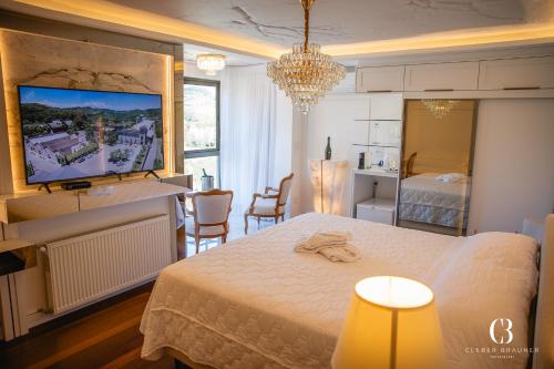 a hotel room with a bed and a dining room at Casa Valduga Pousada Boutique in Bento Gonçalves