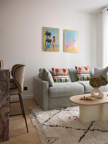 a living room with a couch and a table at Le XV Cannes in Cannes