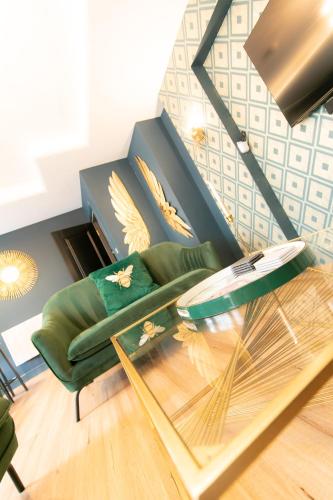 a living room with a green couch and a glass table at The Old Bank Apartments in Blackpool