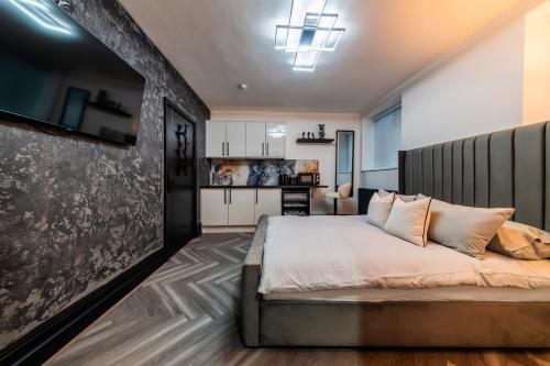 a bedroom with a large bed and a kitchen at MyNites in Birmingham