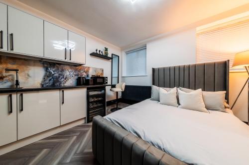 a bedroom with a large bed and white cabinets at MyNites in Birmingham