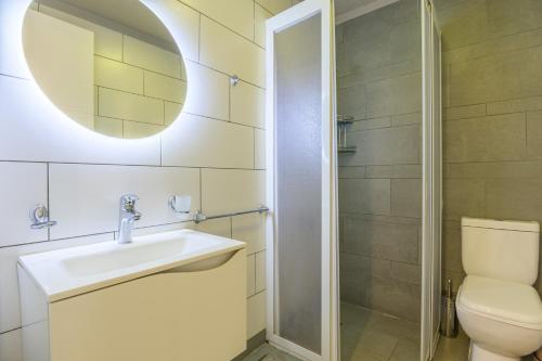 a bathroom with a sink and a toilet and a mirror at Villagio Resort in Zaarour in Zaarour