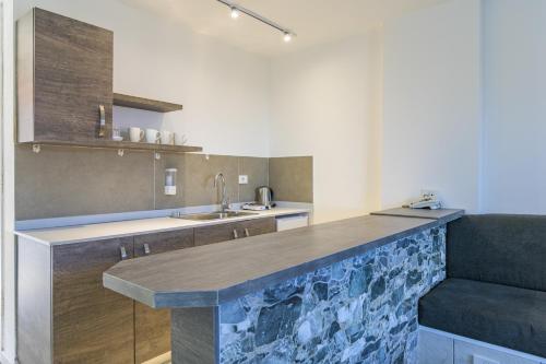 a kitchen with a large counter with a sink and a counter sidx sidx at Villagio Resort in Zaarour in Zaarour