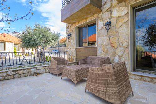a patio with wicker chairs and a table at Villagio Resort in Zaarour in Zaarour