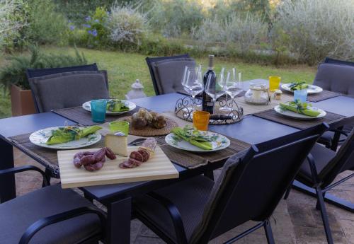 a wooden table with plates of food on it at Relax Palazzo Monaci in Asciano