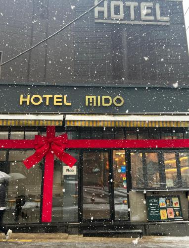 a hotel micoco with a red bow in the snow at Hotel MIDO Myeongdong in Seoul