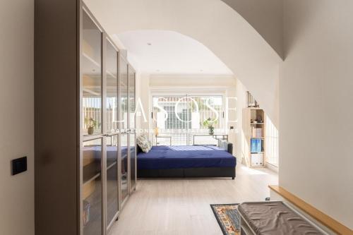 a bedroom with a blue bed and a window at Vacation house with garden in the foothills in Barcelona