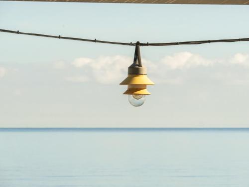 a light bulb hanging from a clothes line at Hostal Empúries in L'Escala
