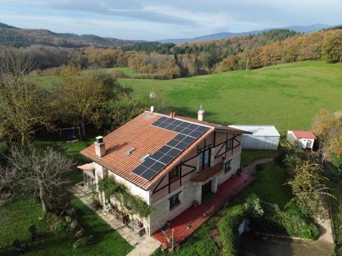 an aerial view of a house with solar panels on the roof at Solapetxea Loft rural in Elosu