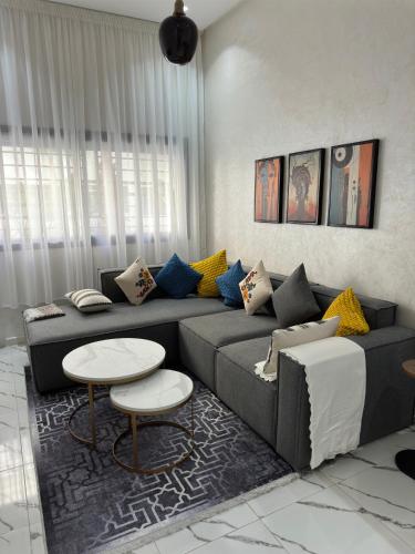 a living room with a couch and a table at Magnificent Cozy New Luxury Condo in Prime Casablanca Location in Les Camps