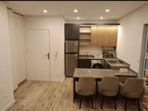 a kitchen with a table and chairs in a room at Maison 7 New Cairo in Cairo