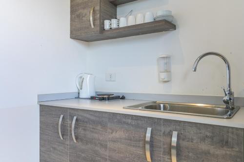 a kitchen with a sink and a counter top at Villagio Resort in Zaarour in Zaarour