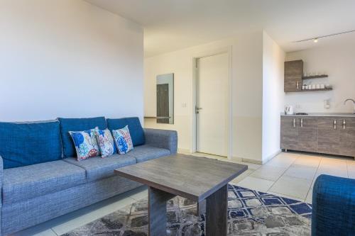 a living room with a blue couch and a table at Villagio Resort in Zaarour in Zaarour
