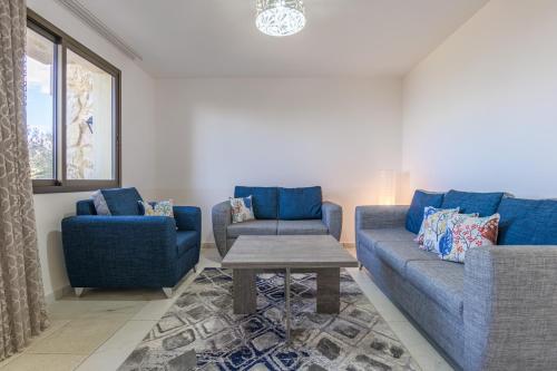 a living room with two blue couches and a table at Villagio Resort in Zaarour in Zaarour
