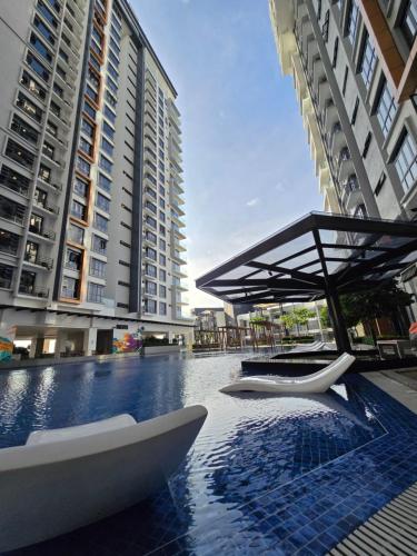 a pool with a table and a boat on it at K Avenue Kota Kinabalu by Merveille - Sabah in Donggongon