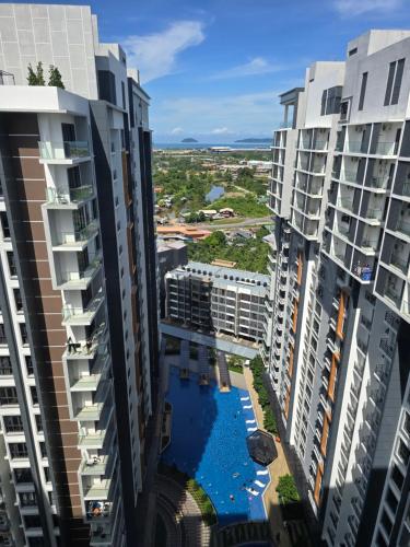 an aerial view of two tall buildings with a swimming pool at K Avenue Kota Kinabalu by Merveille - Sabah in Donggongon