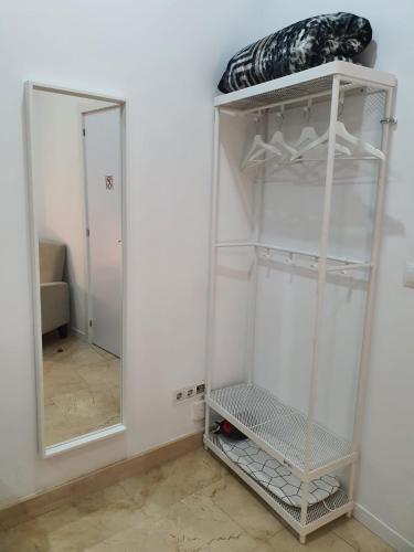 a white closet with a mirror in a room at Habitaciones Chueca in Madrid