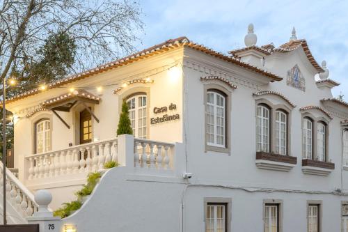 a white house with a white fence at Casa da Estefânea in Sintra