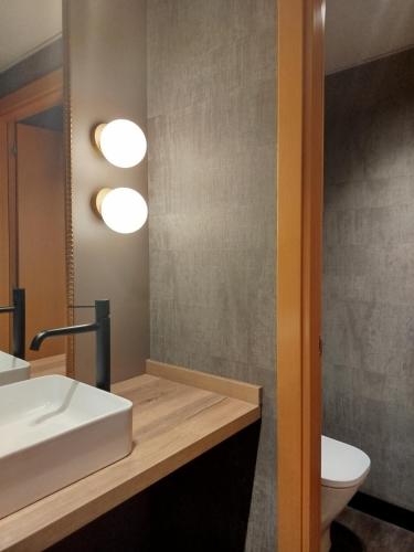 a bathroom with a white sink and a toilet at Hotel Villa de Zaragoza in Casetas