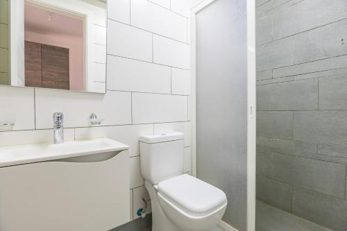 a white bathroom with a toilet and a sink at Villagio Resort in Zaarour in Zaarour