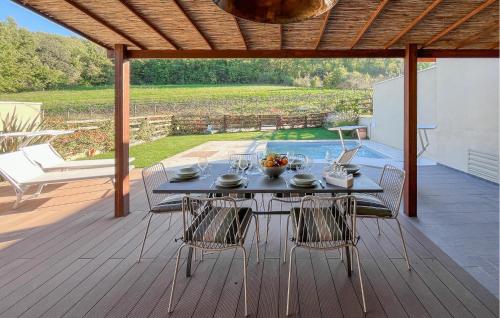 a table and chairs on a wooden deck with a patio at 3 Bedroom Beautiful Home In Montebuono in San Savino