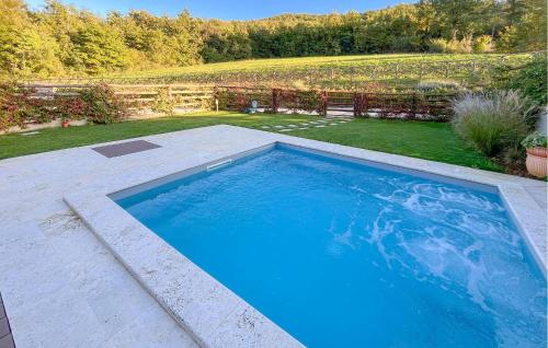 a large blue swimming pool in a yard at 3 Bedroom Beautiful Home In Montebuono in San Savino