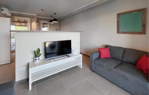 a living room with a couch and a flat screen tv at Amazing Home In Montebuono in Montemelino