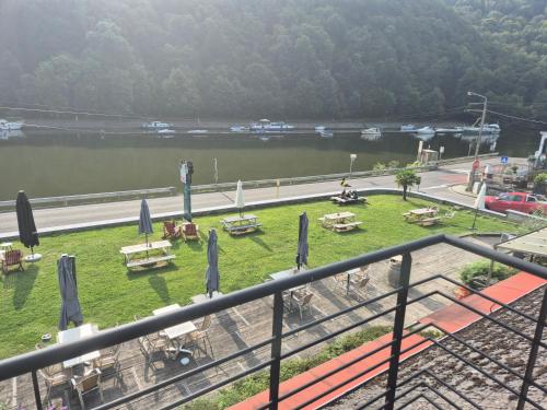 a view of a river with tables and umbrellas at Panama RIO in Waulsort