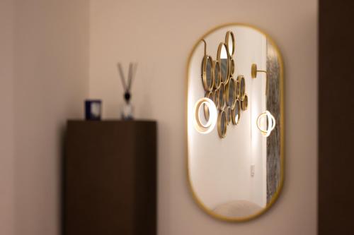 a mirror hanging on a wall in a room at Enjoyhousebracciano Suite 3 in Bracciano