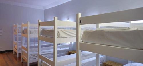 a room with three bunk beds in a room at Santa Maria Hostel in Funchal