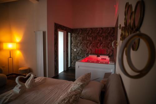 a bedroom with a bed with red lights on it at Enjoyhousebracciano Suite 3 in Bracciano