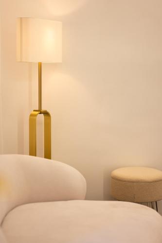 a bedroom with a lamp and a chair at Enjoyhousebracciano Suite 3 in Bracciano
