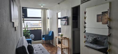 a living room with a couch and a window at Edifício Mirante do Vale in Sao Paulo
