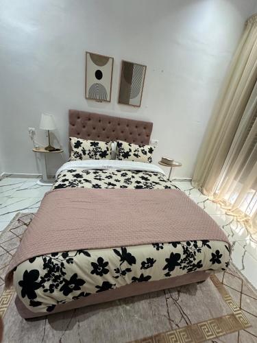 a bedroom with a bed with a black and white comforter at Magnificent Cozy New Luxury Condo in Prime Casablanca Location in Les Camps